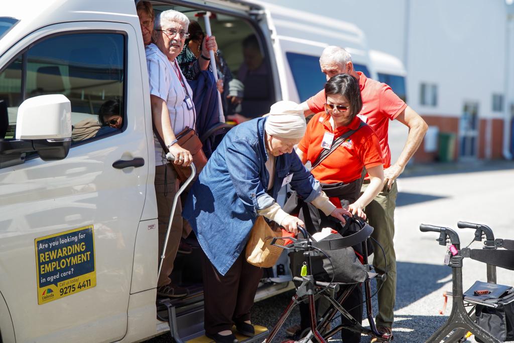 Umbrella Support worker helping client